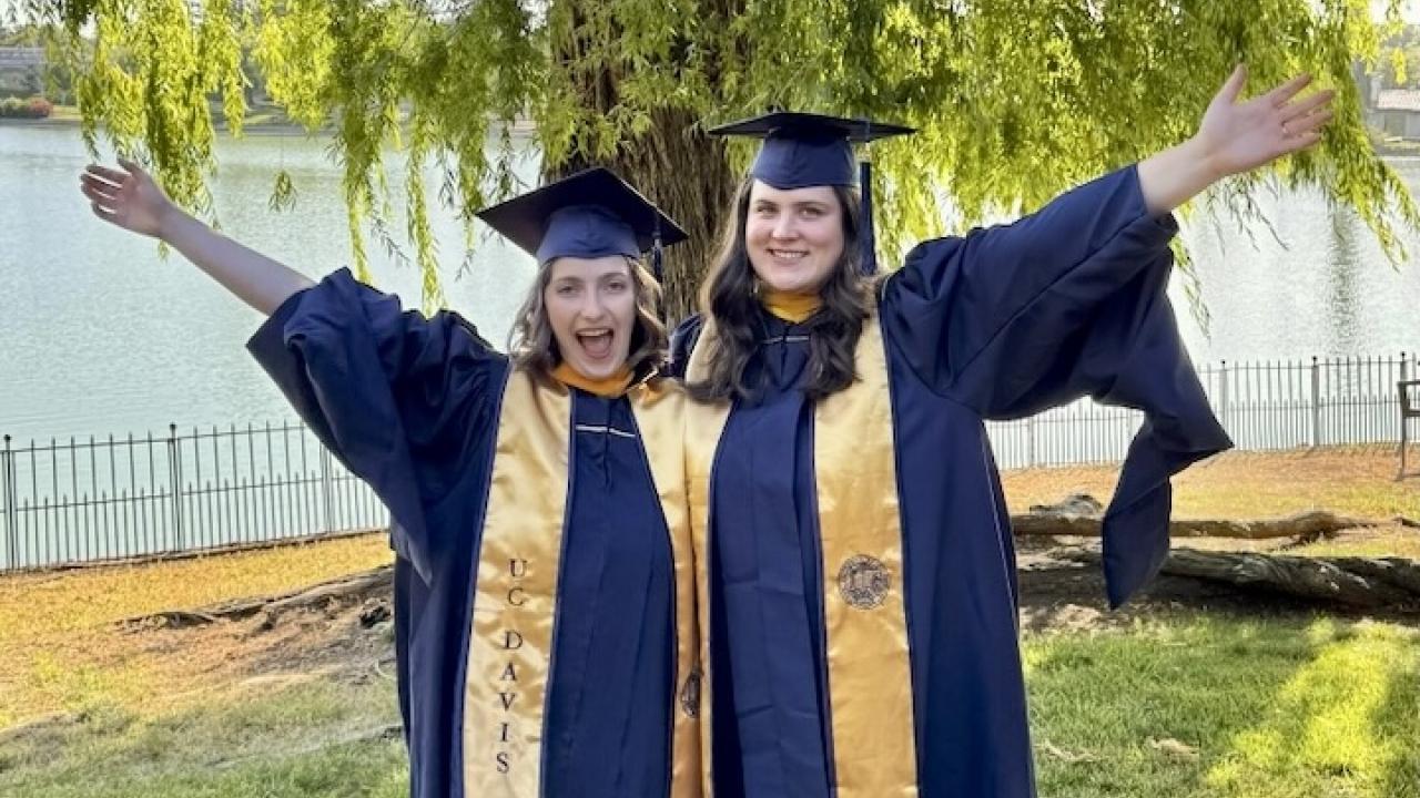 Graduates in front of tree